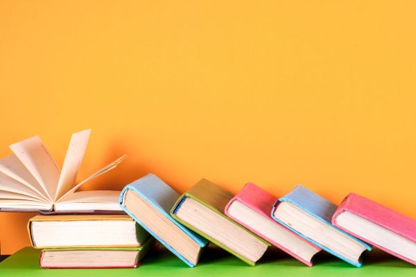 A stack of books on a table, inspiring reading for Earth Day